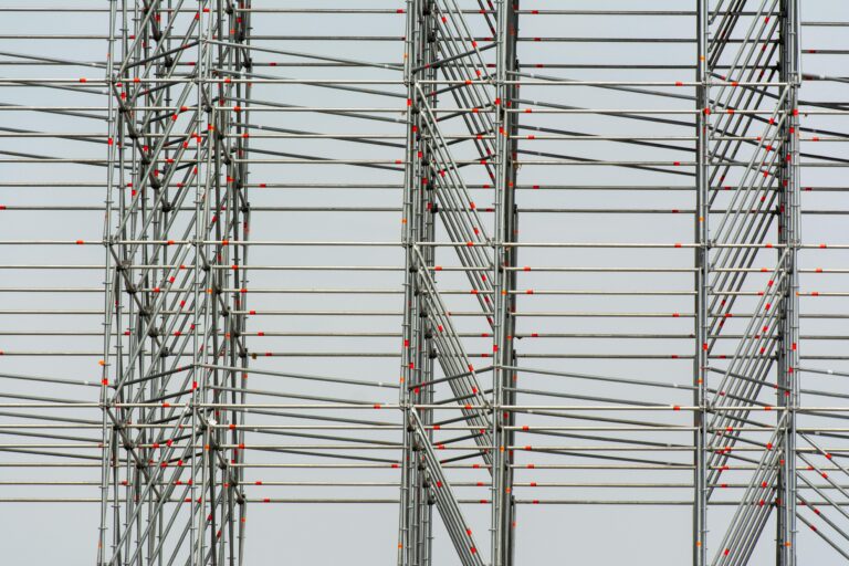 Close-up view of modern steel scaffolding displaying linear patterns and intersections.